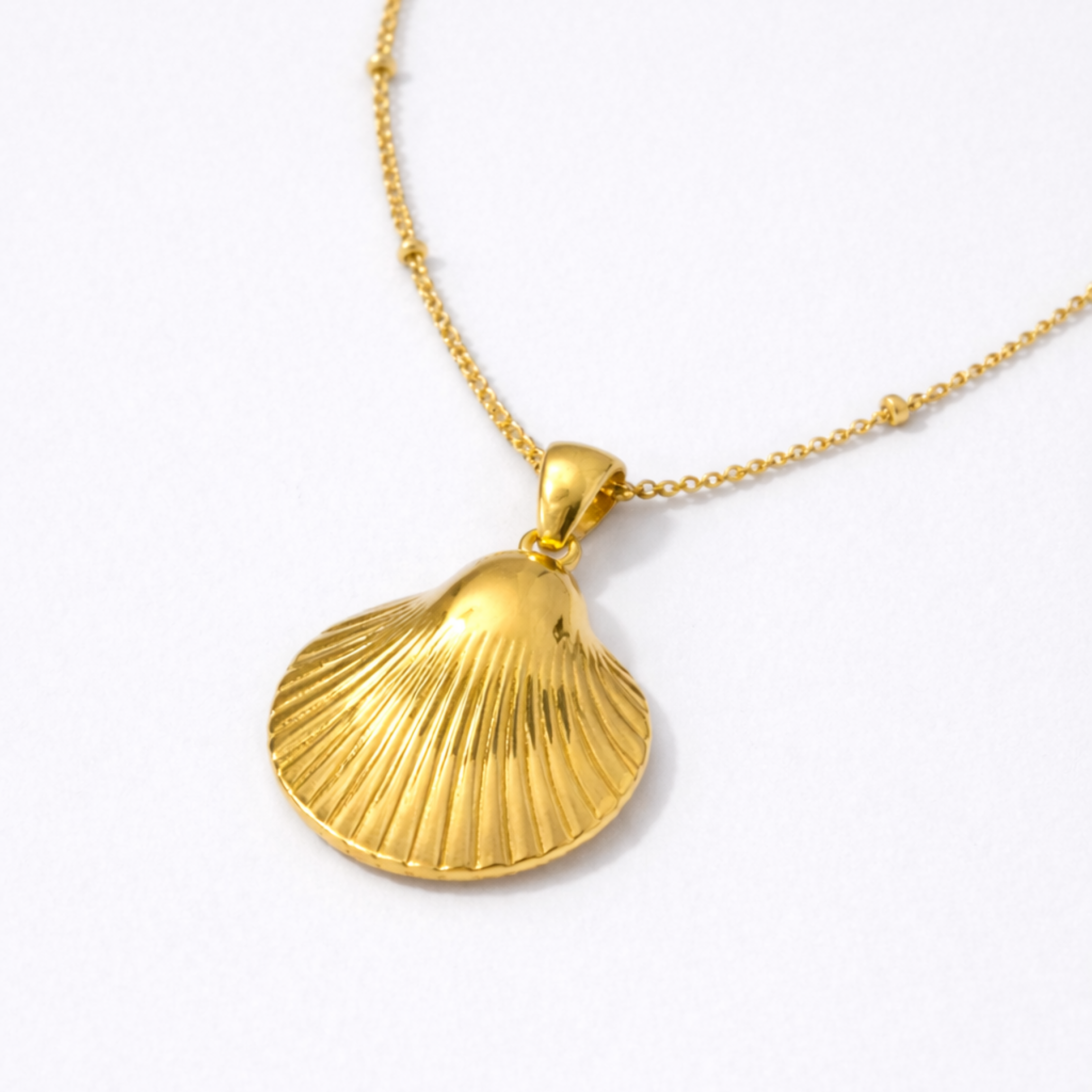 Gold seashell pendant necklace close-up