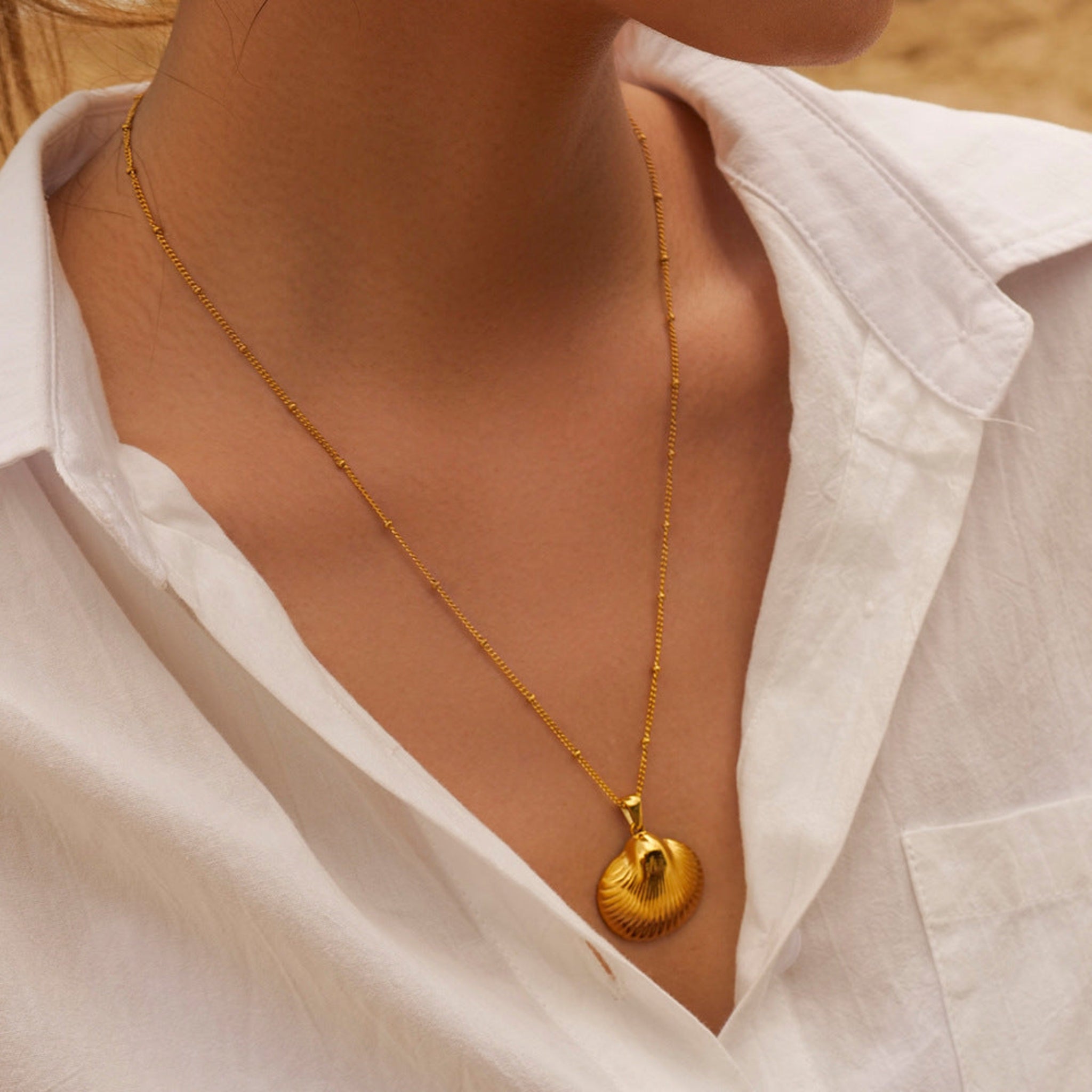 Woman wearing 18K gold plated seashell pendant necklace